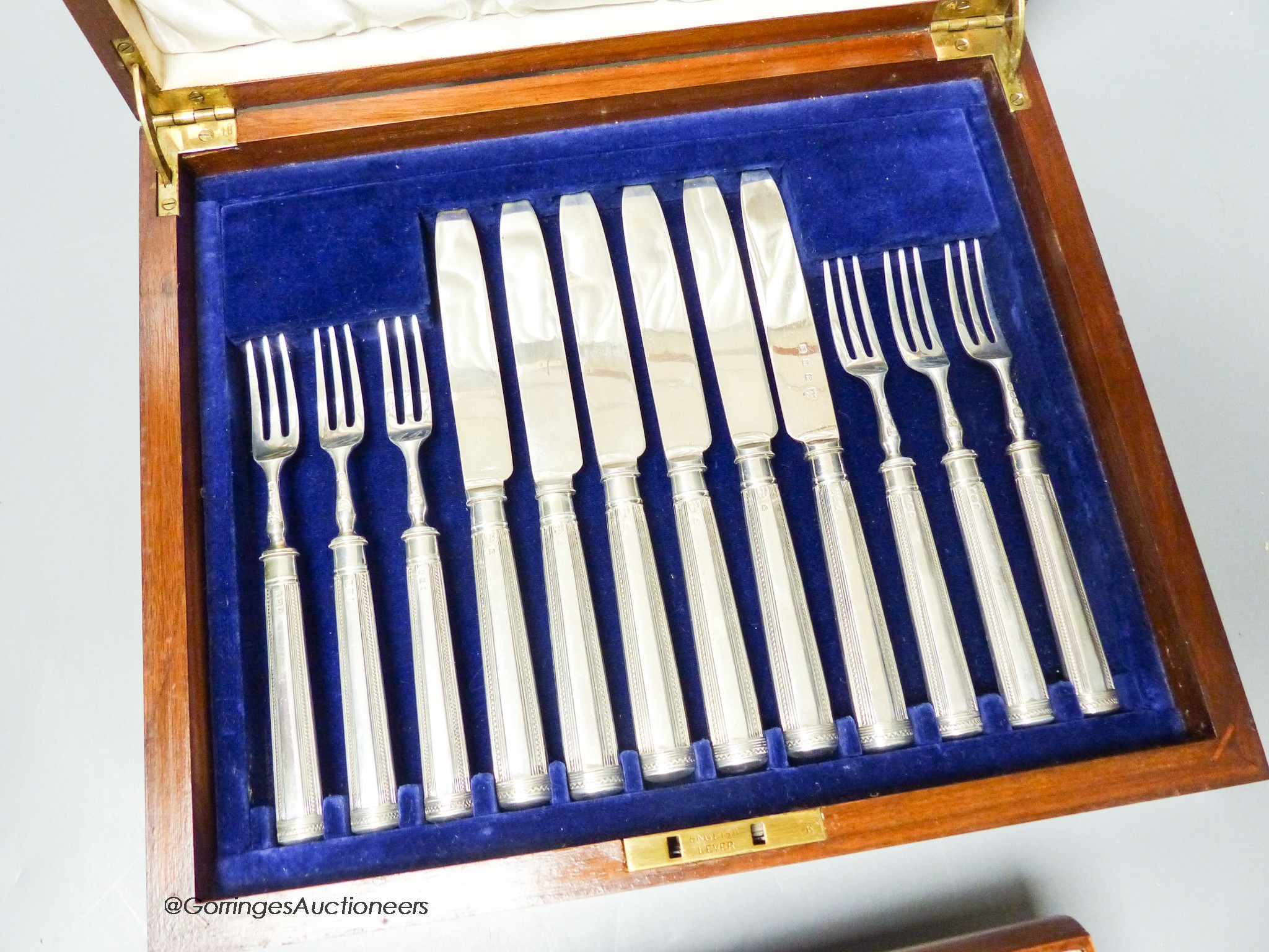 A cased set of twelve pairs of George V silver bladed fruit eaters (weighted handles), Tessiers Ltd, London, 1934.